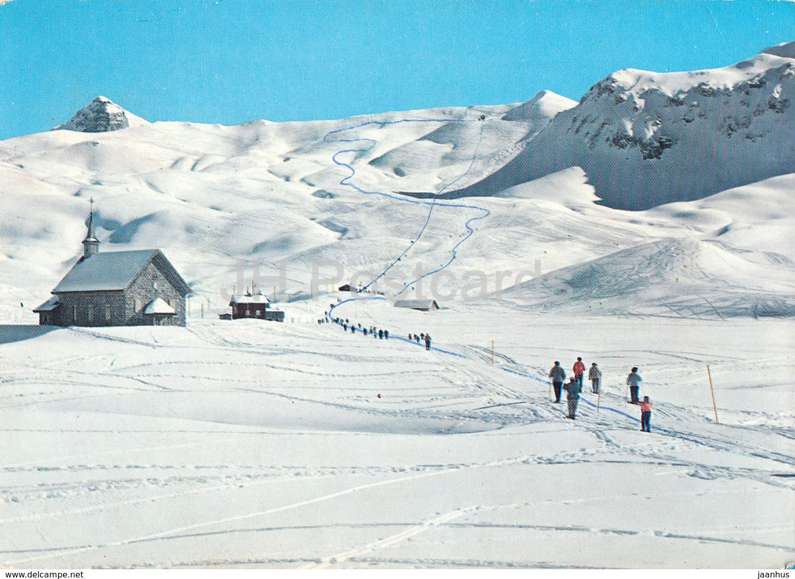 Melchsee-Frutt in Switzerland - a group of people skiing down a snow covered mountain.