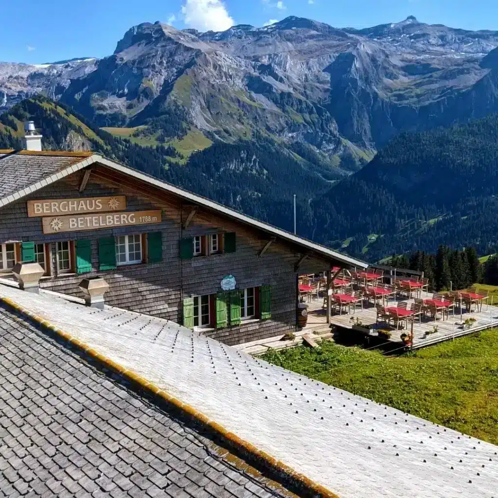 Betelberg in Switzerland: a wooden building with mountains in the background.