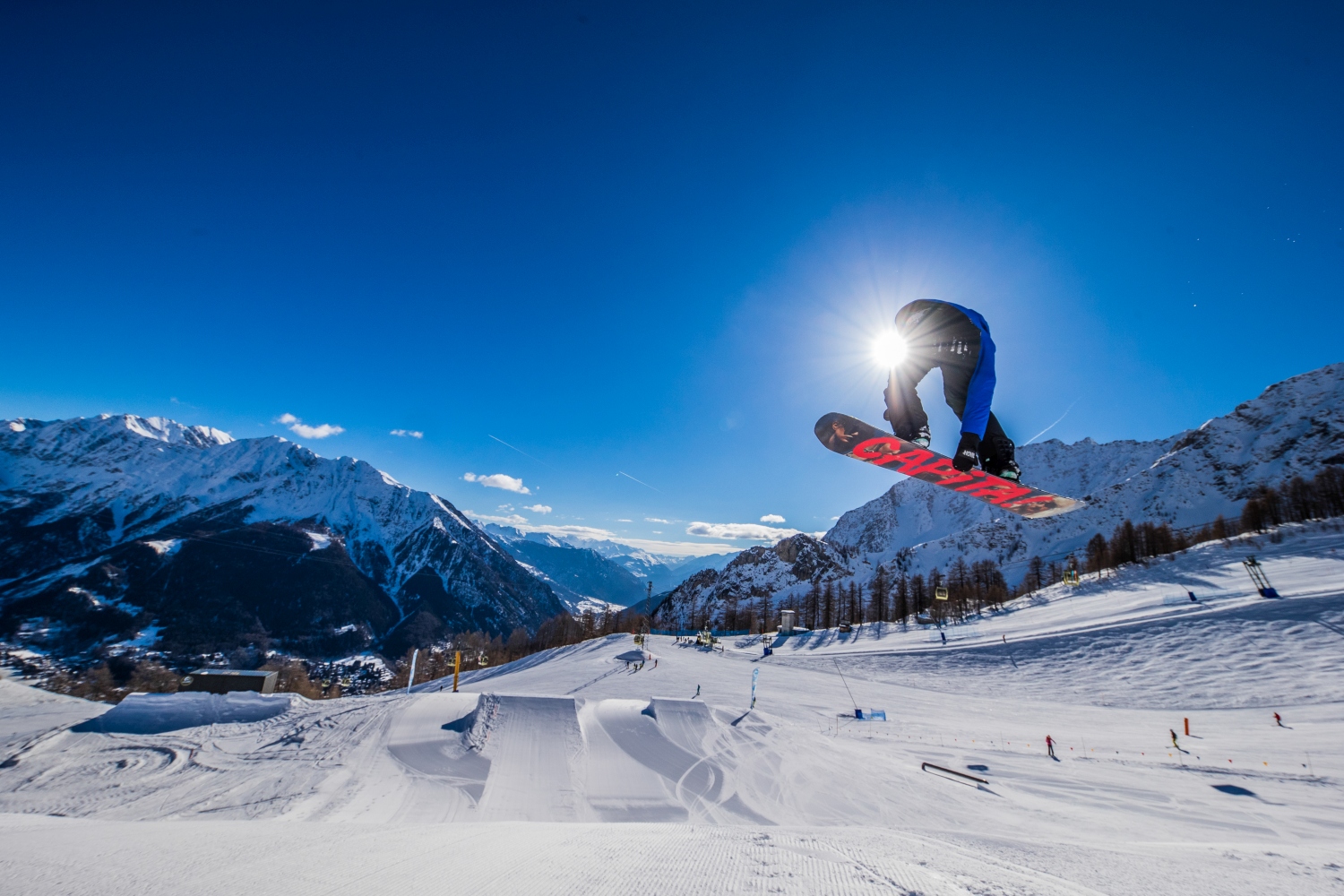 Courmayeur in Italy - a man flying through the air while riding a snowboard.