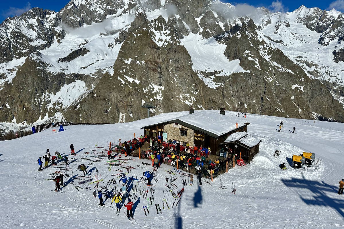 Courmayeur in Italy - a group of people skiing on a snowy mountain.