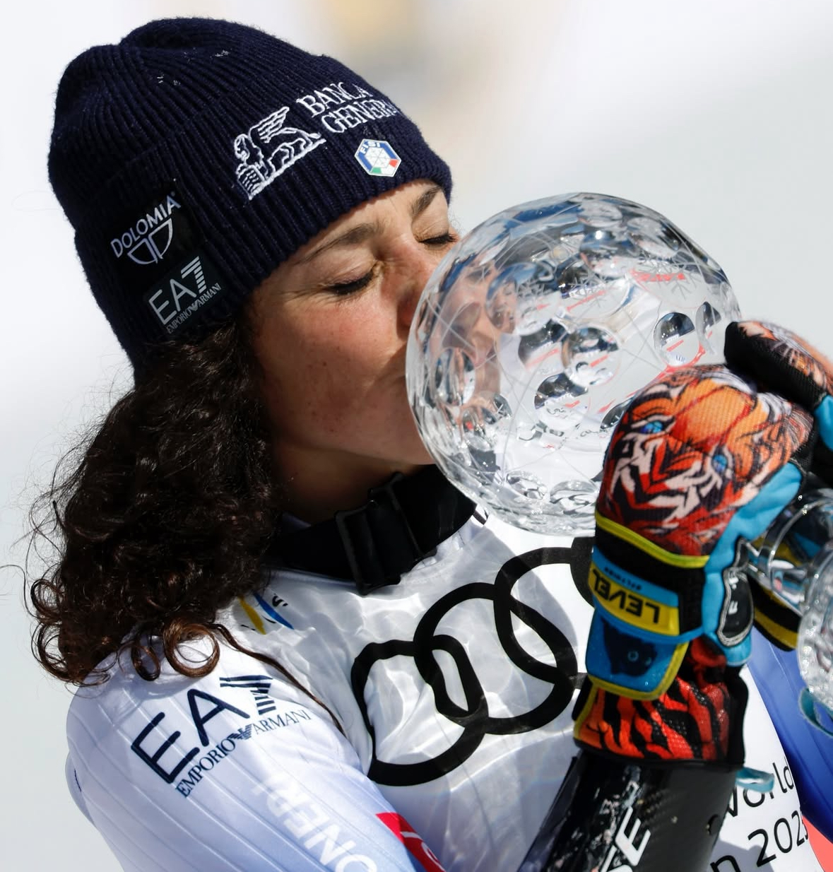 Courmayeur in Italy - a woman in ski gear drinking from a water bottle.