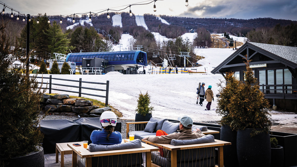Windham Mountain in USA - a group of people sitting at a table in the snow.