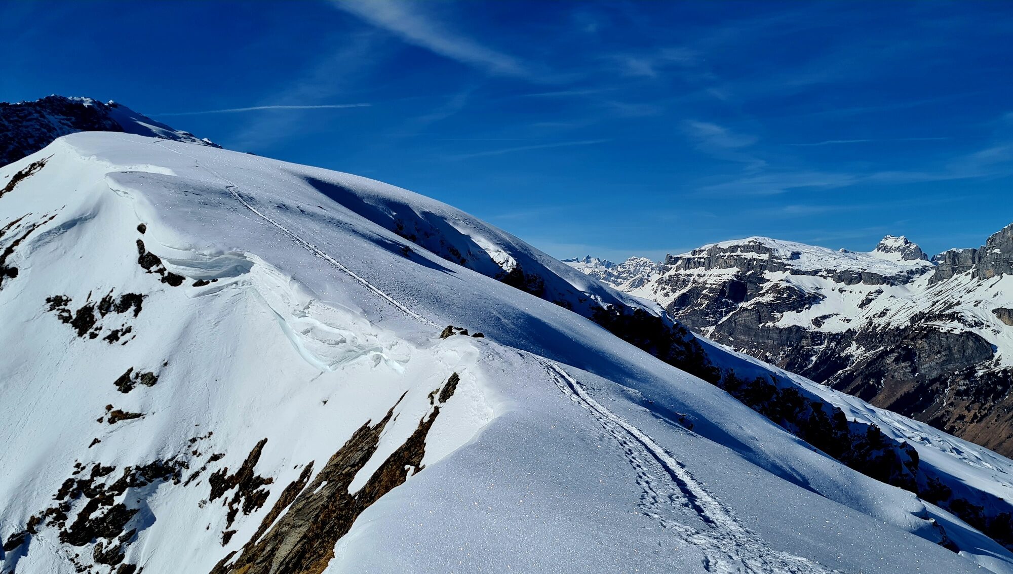 Urnerboden in Switzerland - a person on a snowboard on a snowy mountain.