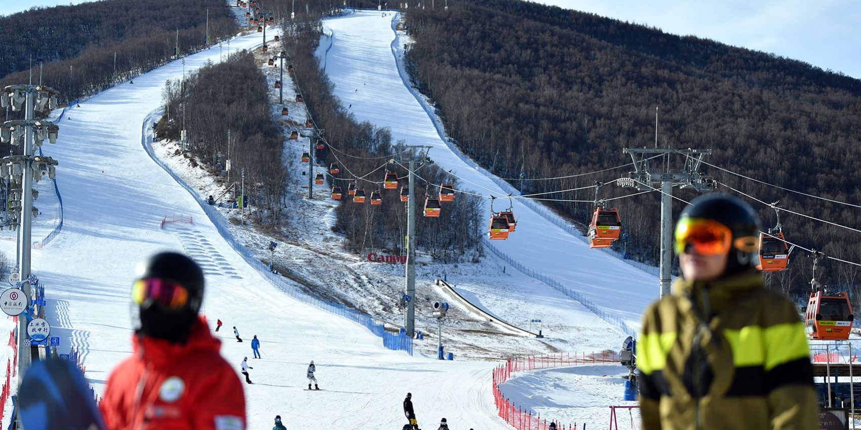 Thaiwoo Ski Resort in China - a group of people walking down a snow covered slope.