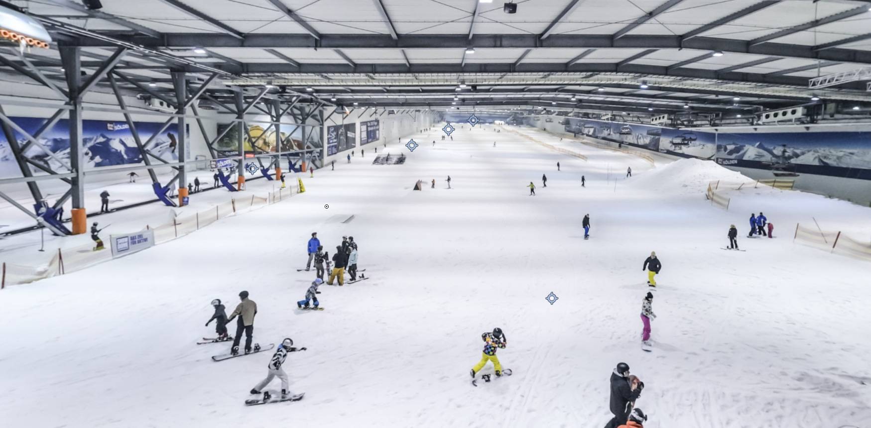 Snow Dome Bispingen in Germany - a group of people skiing down a snow covered slope.
