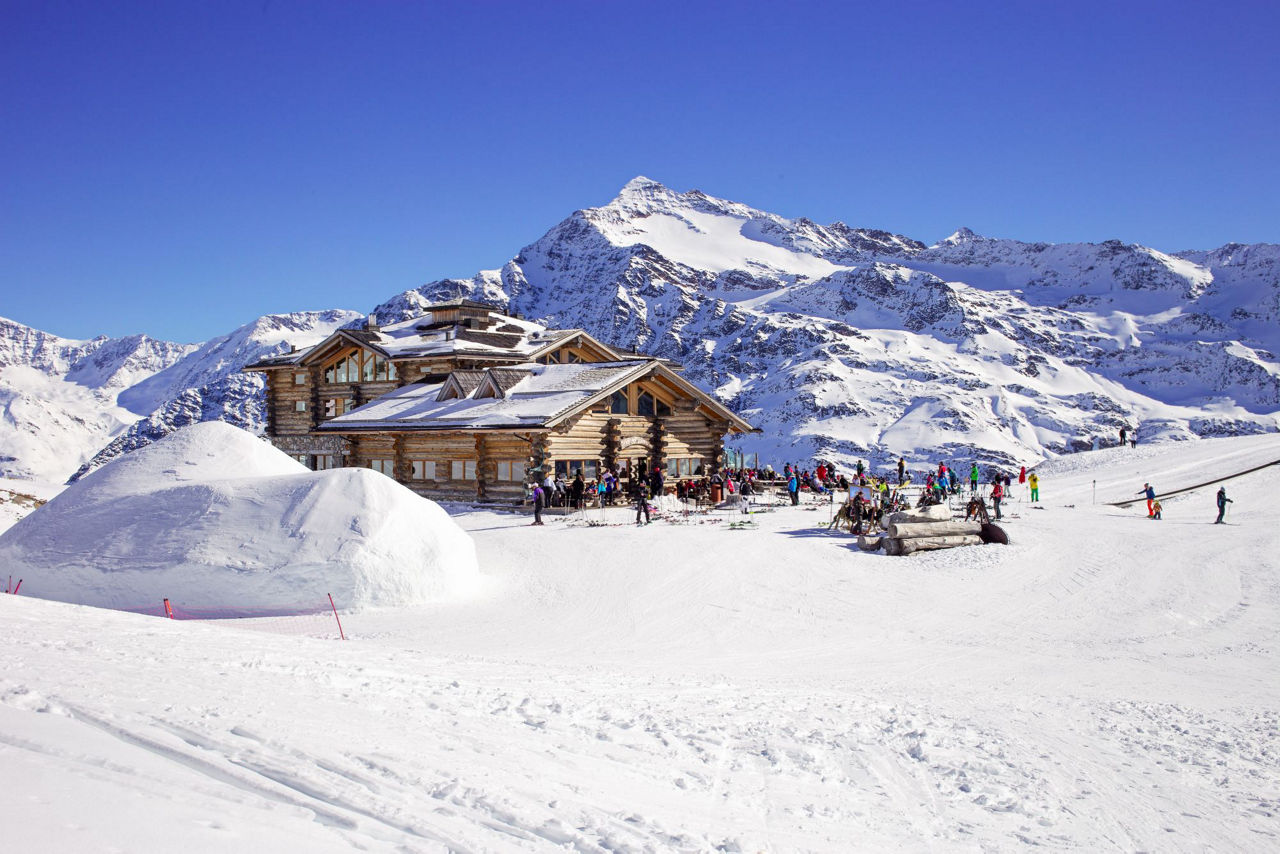 Santa Caterina Valfurva in Italy - a group of people skiing down a snowy slope.