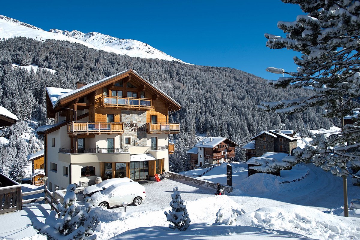 Santa Caterina Valfurva in Italy - a house in the snow with mountains in the background.