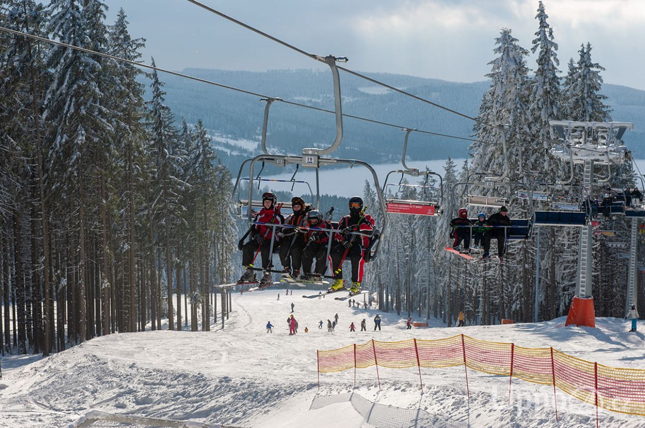 Lipno in Czech Republic - a ski lift going up a snowy slope.