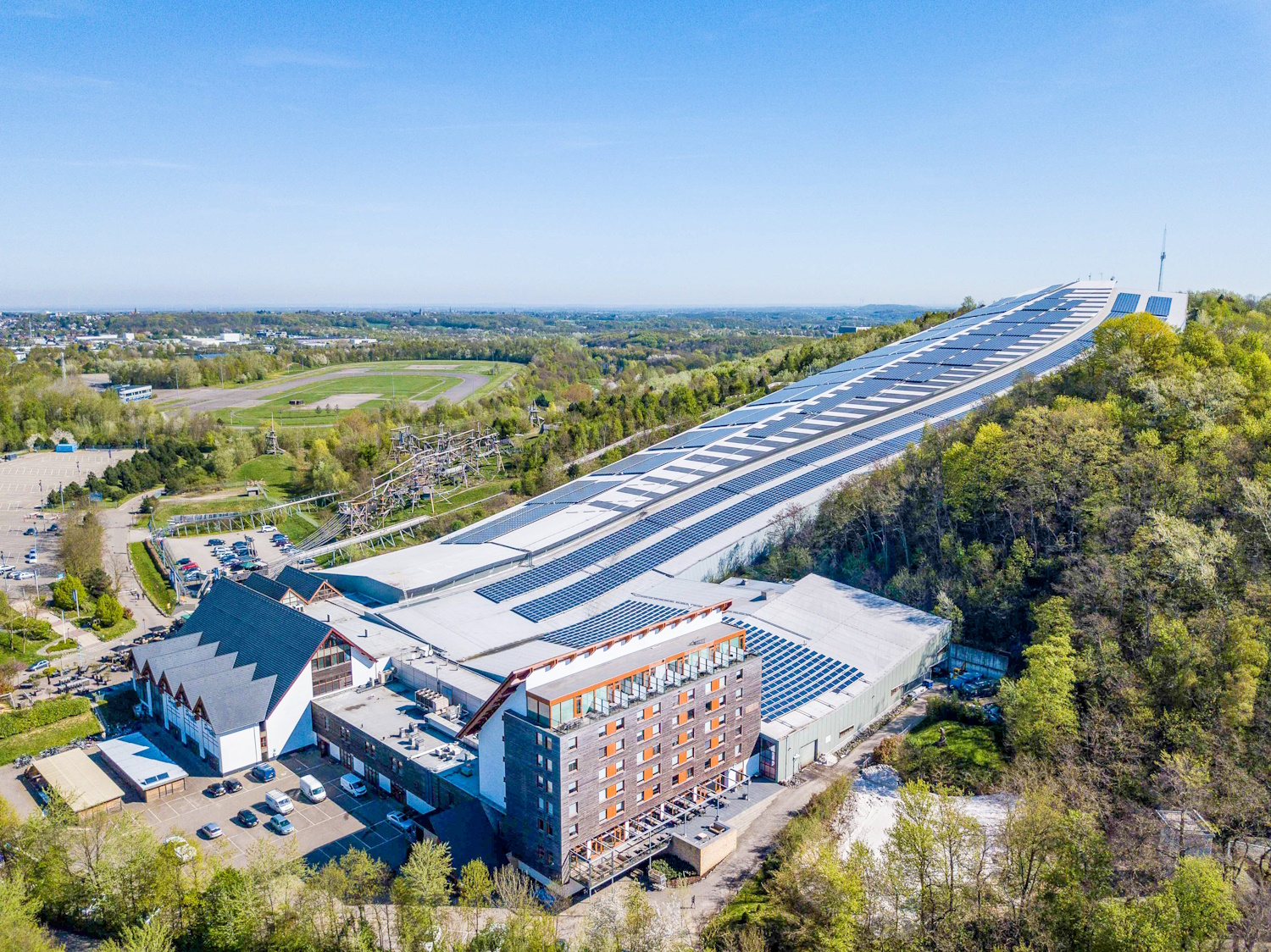SnowWorld Landgraaf in Netherlands: an aerial view of a large building in the forest.