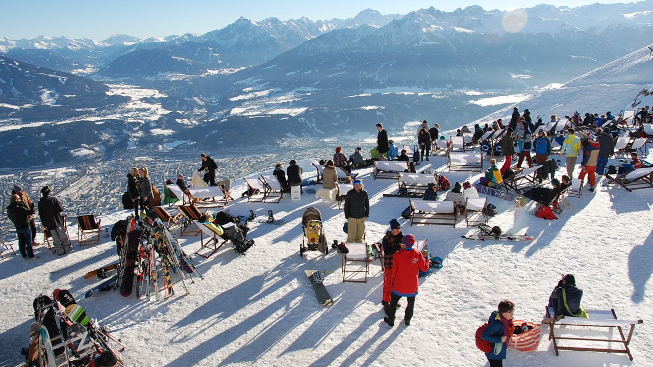 Nordkette – Innsbruck in Austria - a group of people standing on top of a snow covered mountain.