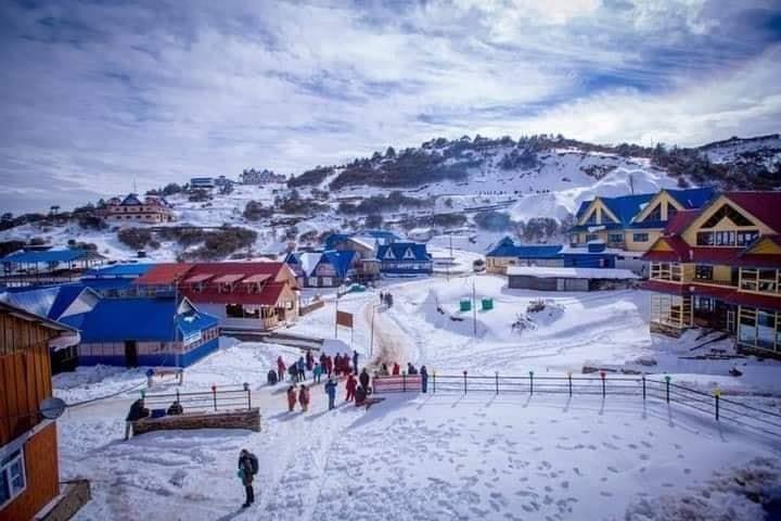 Dolakha Kalinchowk Resort in Nepal - a group of people walking down a snow covered hill.
