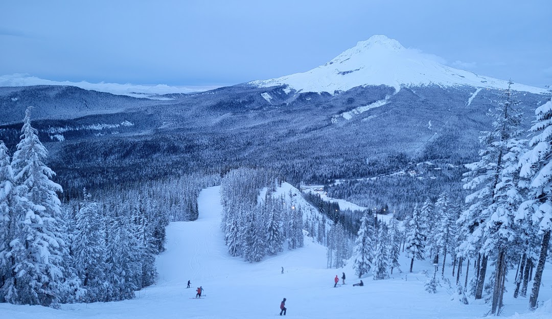 Mt Hood Skibowl in USA - a group of people skiing down a snow covered mountain.