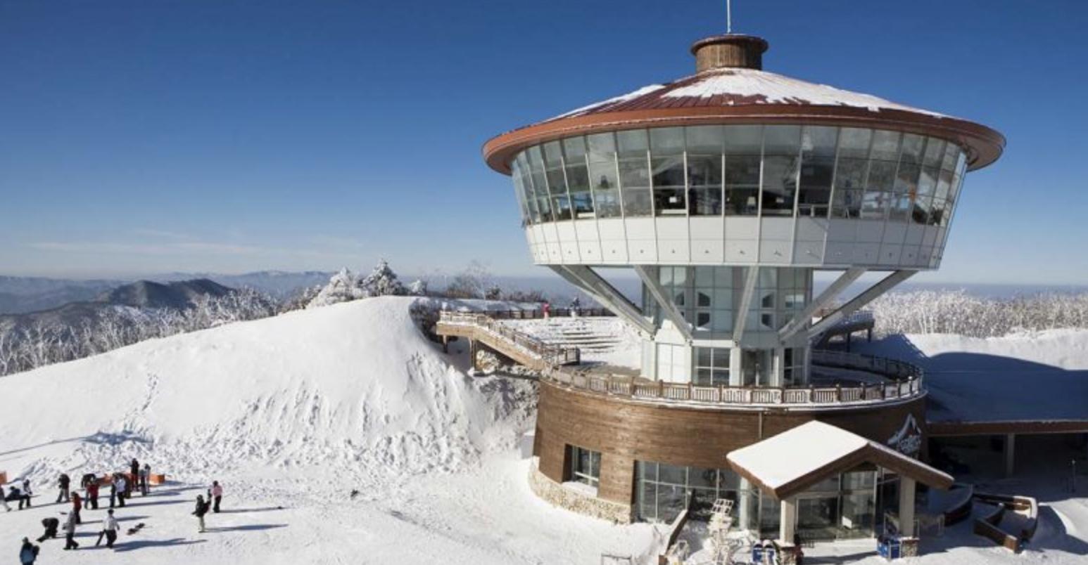High1 Resort in South Korea - a tower on top of a snow covered mountain.