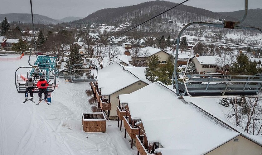 Holiday Valley Resort in USA - a person on a ski lift in the snow.