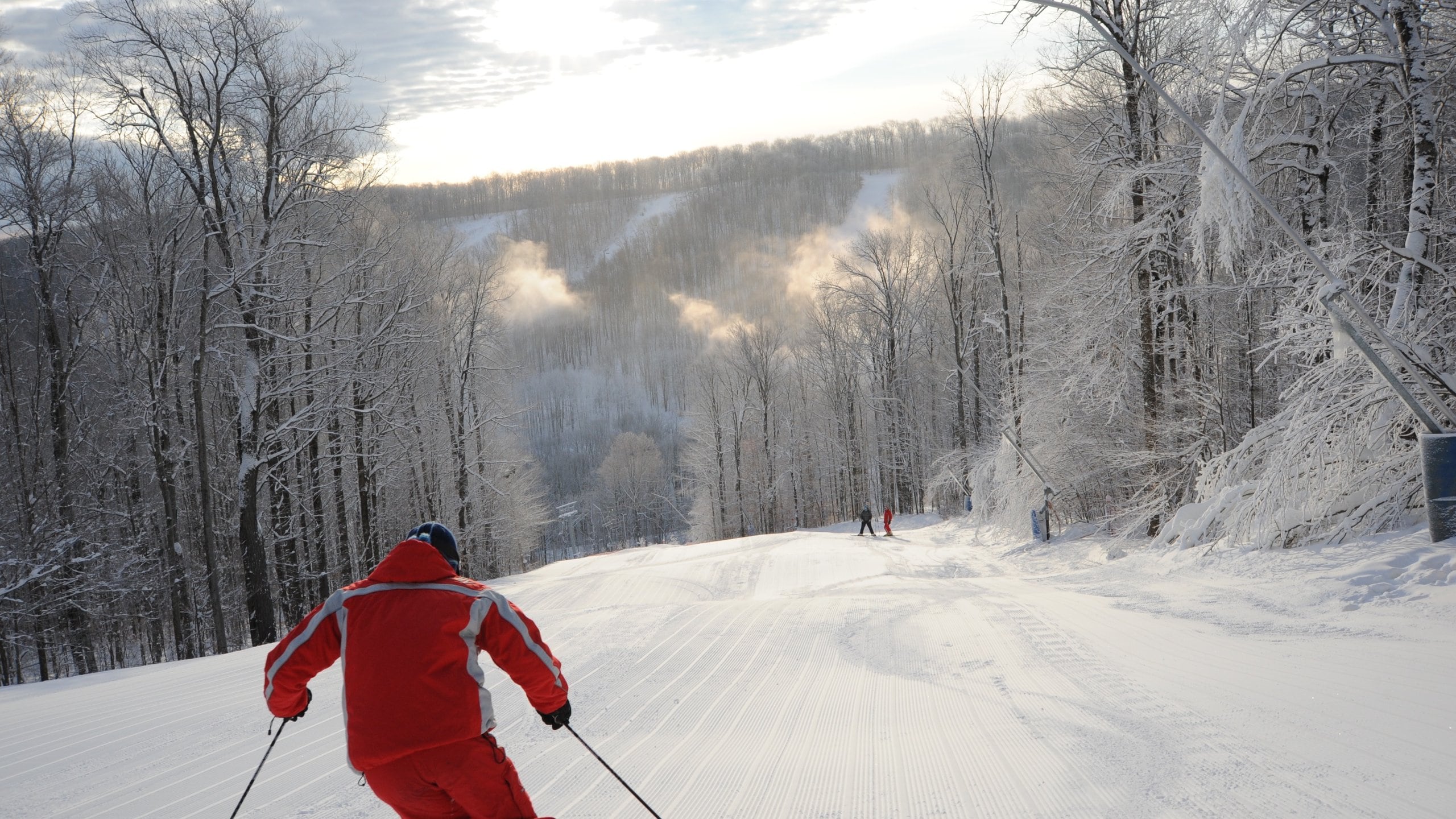 Holiday Valley Resort in USA - a person in a red jacket skiing down a hill.
