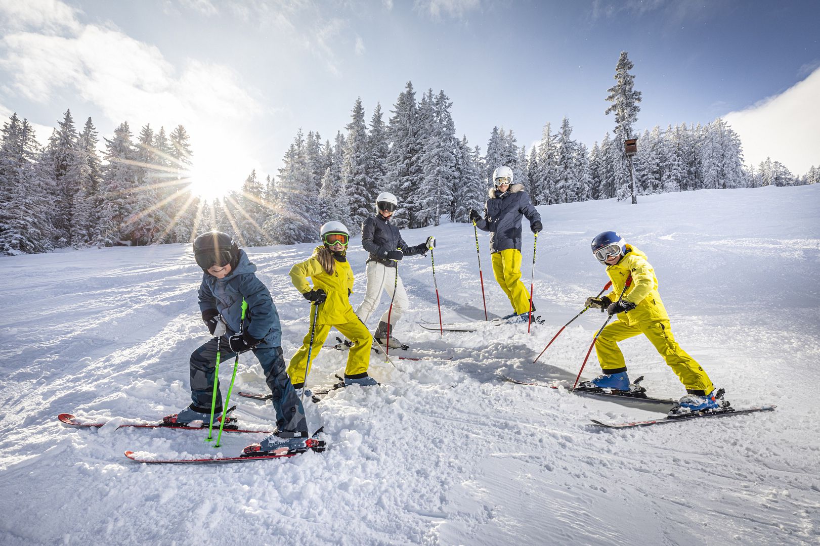 Filzmoos in Austria - a group of people riding skis down a snow covered slope.