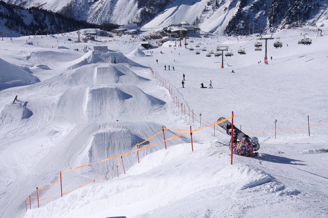 Ischgl Samnaun – Silvretta Arena in Austria - a person on a snowboard in the snow.