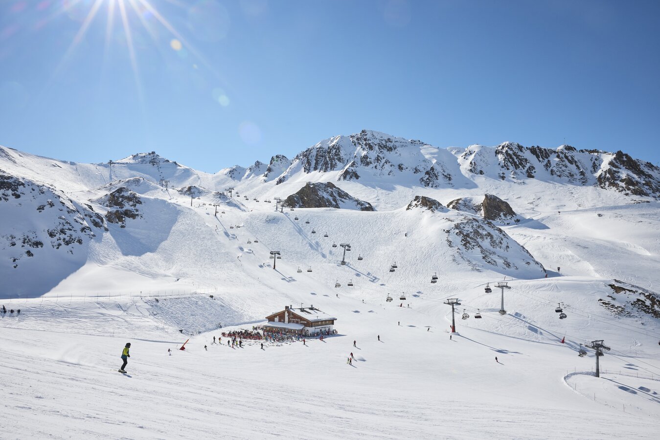 Ischgl Samnaun – Silvretta Arena in Austria - a group of people skiing down a snowy slope.