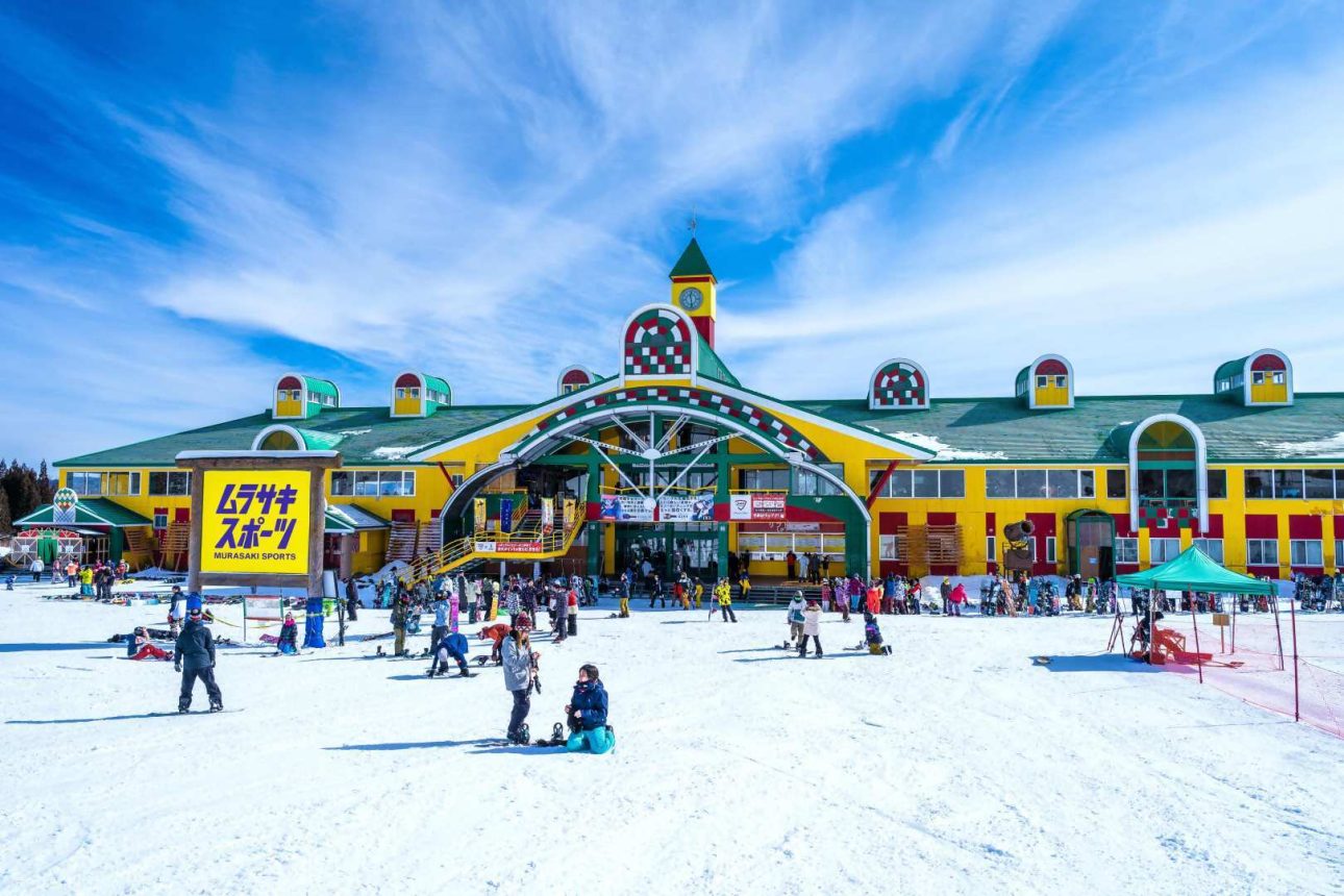 Takasu Snow Park in Japan: a large yellow building with a green roof.