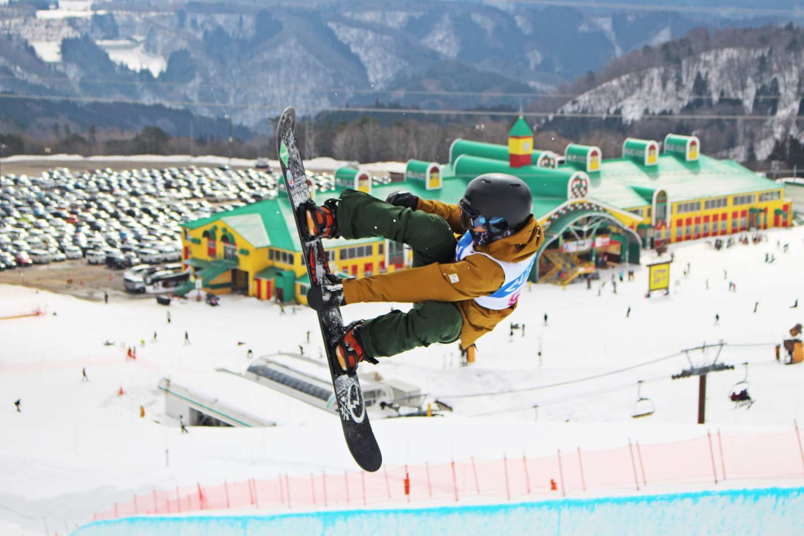 Takasu Snow Park in Japan - a snowboarder doing a trick in the air.