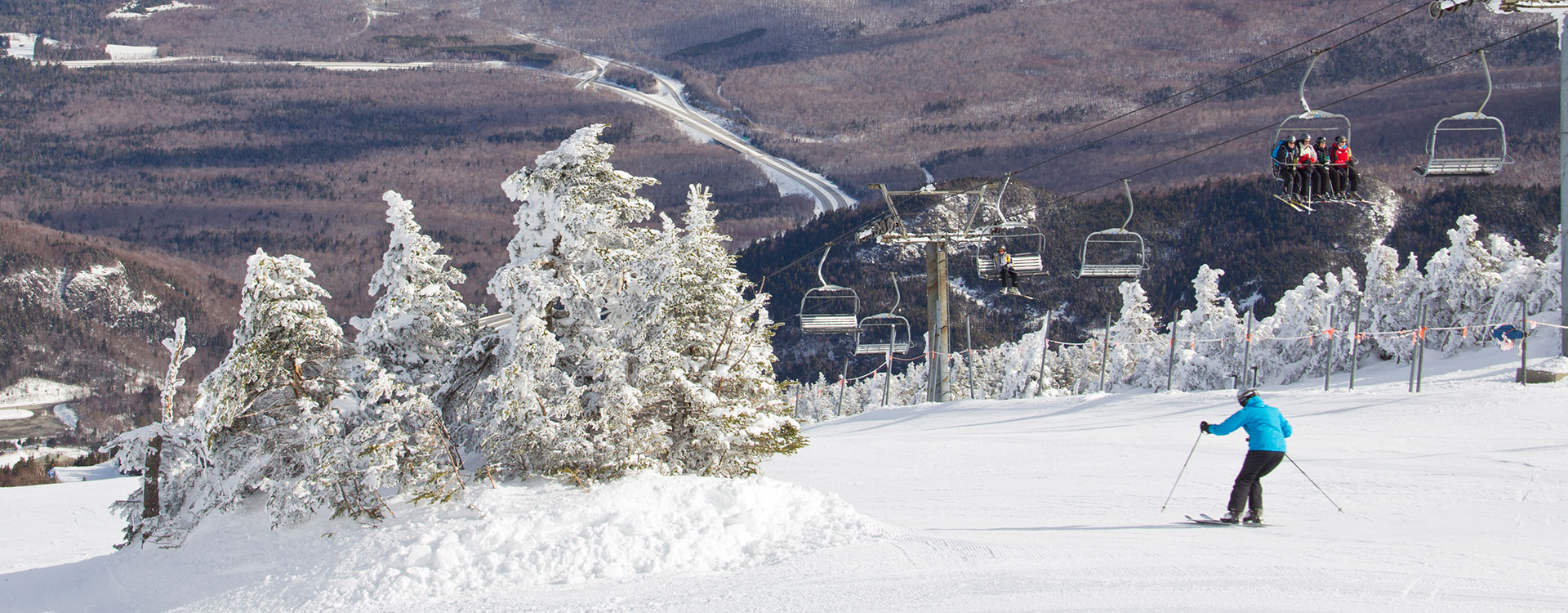 Cannon Mountain in USA - a person riding a ski board down a hill.
