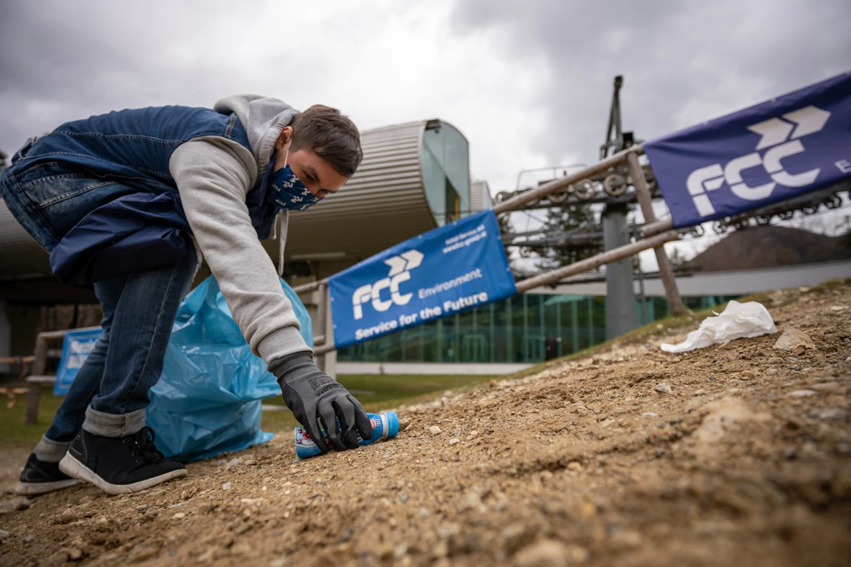 Zauberberg Semmering in Austria - a man in a blue jacket and black gloves is digging dirt on the ground.