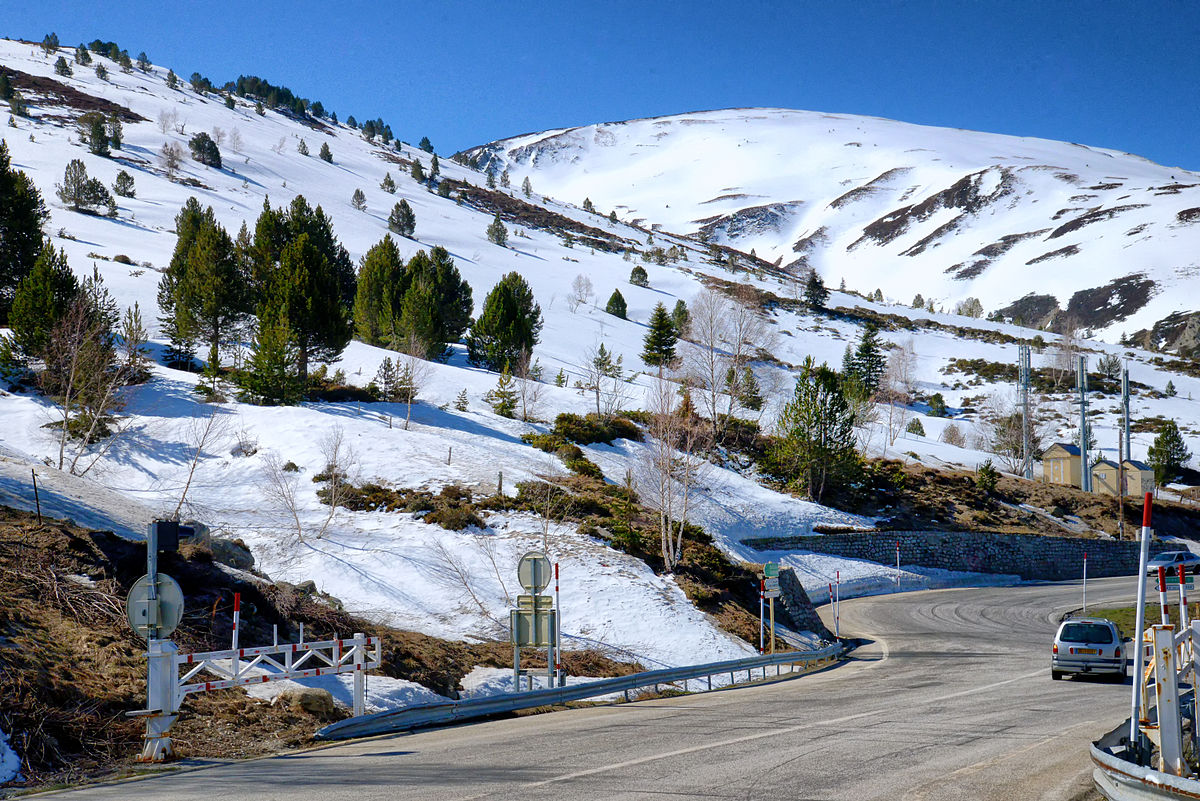 Porté Puymorens in France - a car driving down a road in the mountains.