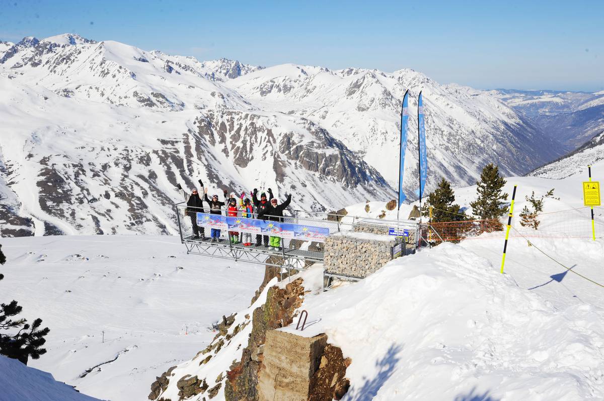 Porté Puymorens in France - a group of people standing on top of a snowy mountain.