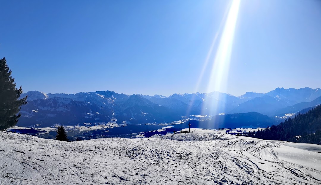 Bergbahnen Ofterschwang- Gunzesried GmbH & Co. KG in Germany - the sun is shining over the snow covered mountains.