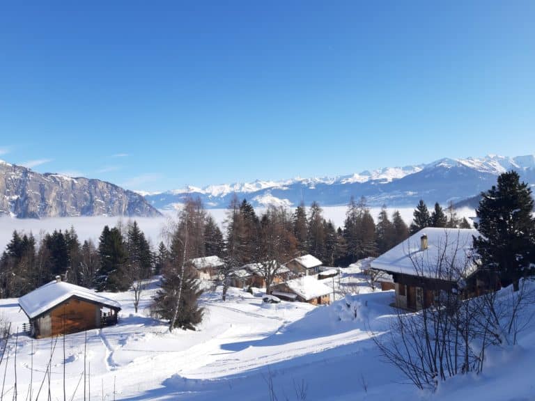 View of Ovronnaz in Switzerland's Valais region showing a winter sports centre stunning winter scenery a ski resort and a chalet. The picture depicts a quintessential winter sports scene.