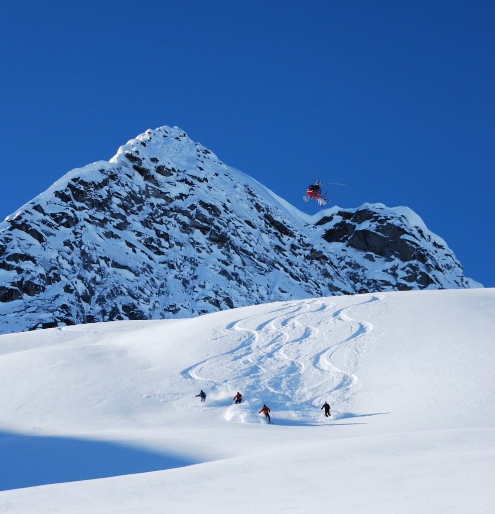 Eagle Pass Heliskiing in Canada - a person skiing down a snow covered mountain.
