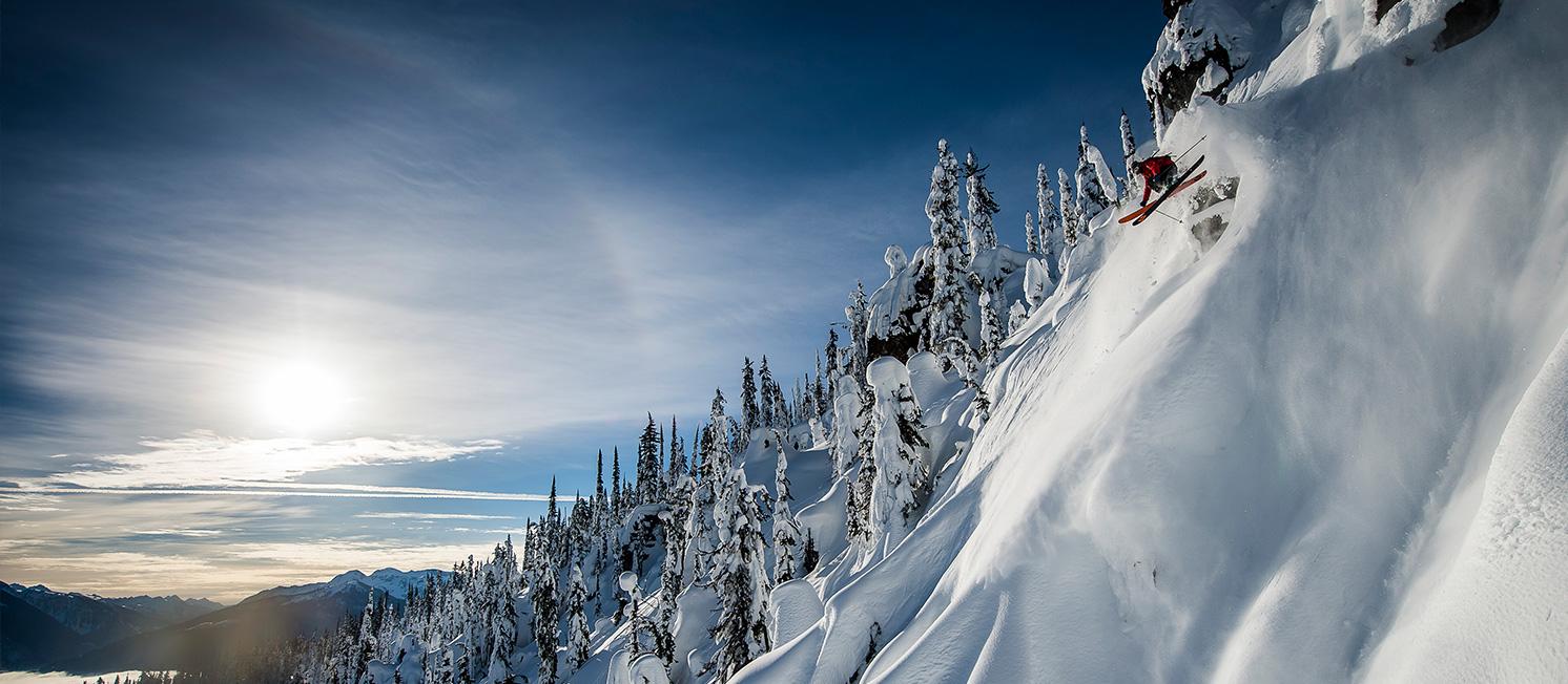 Eagle Pass Heliskiing in Canada - a person skiing down the side of a mountain.