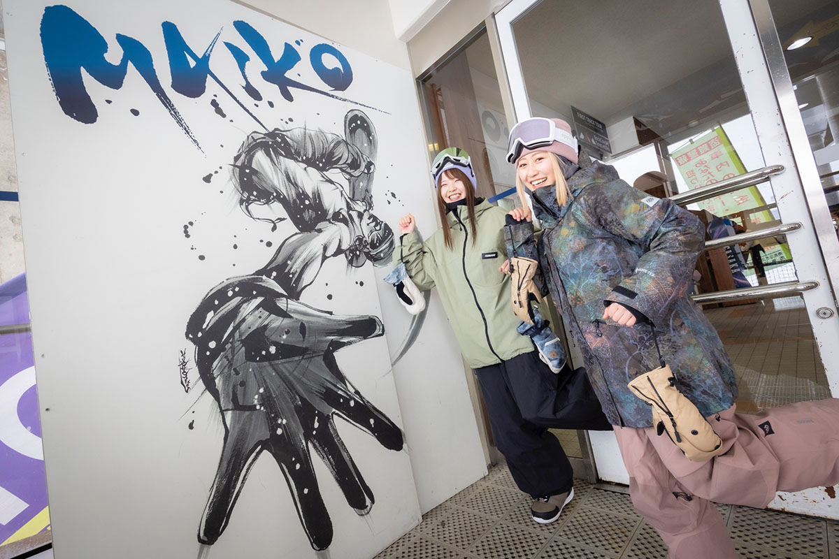Maiko Snow Resort in Japan - two people standing in front of a painting.