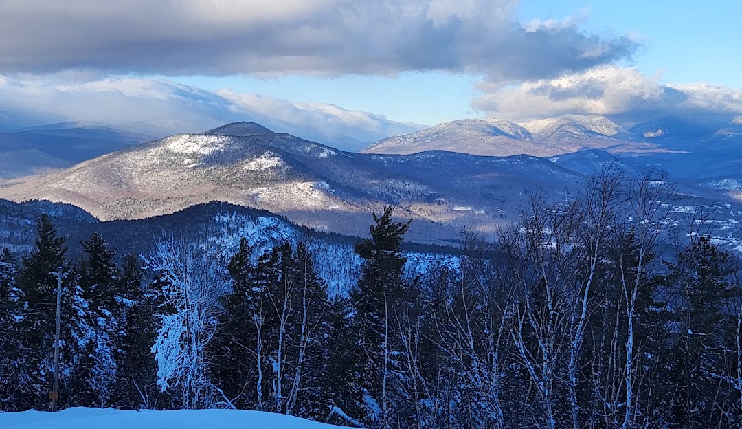 Attitash Mountain Resort in USA - a view from the top of a snowy mountain.