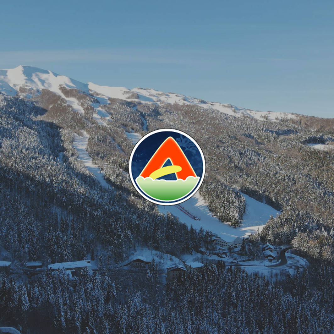 Abetone | Val di Luce in Italy: a ski resort with a mountain in the background.