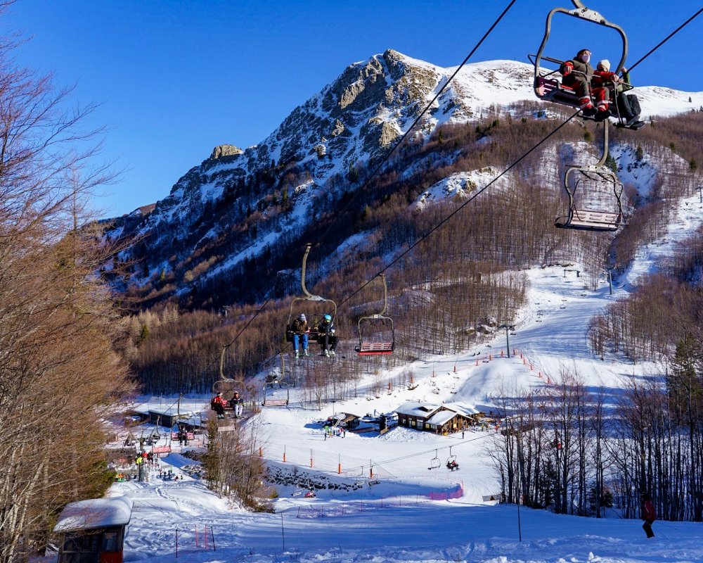 Abetone | Val di Luce in Italy - a ski lift going up the side of a mountain.