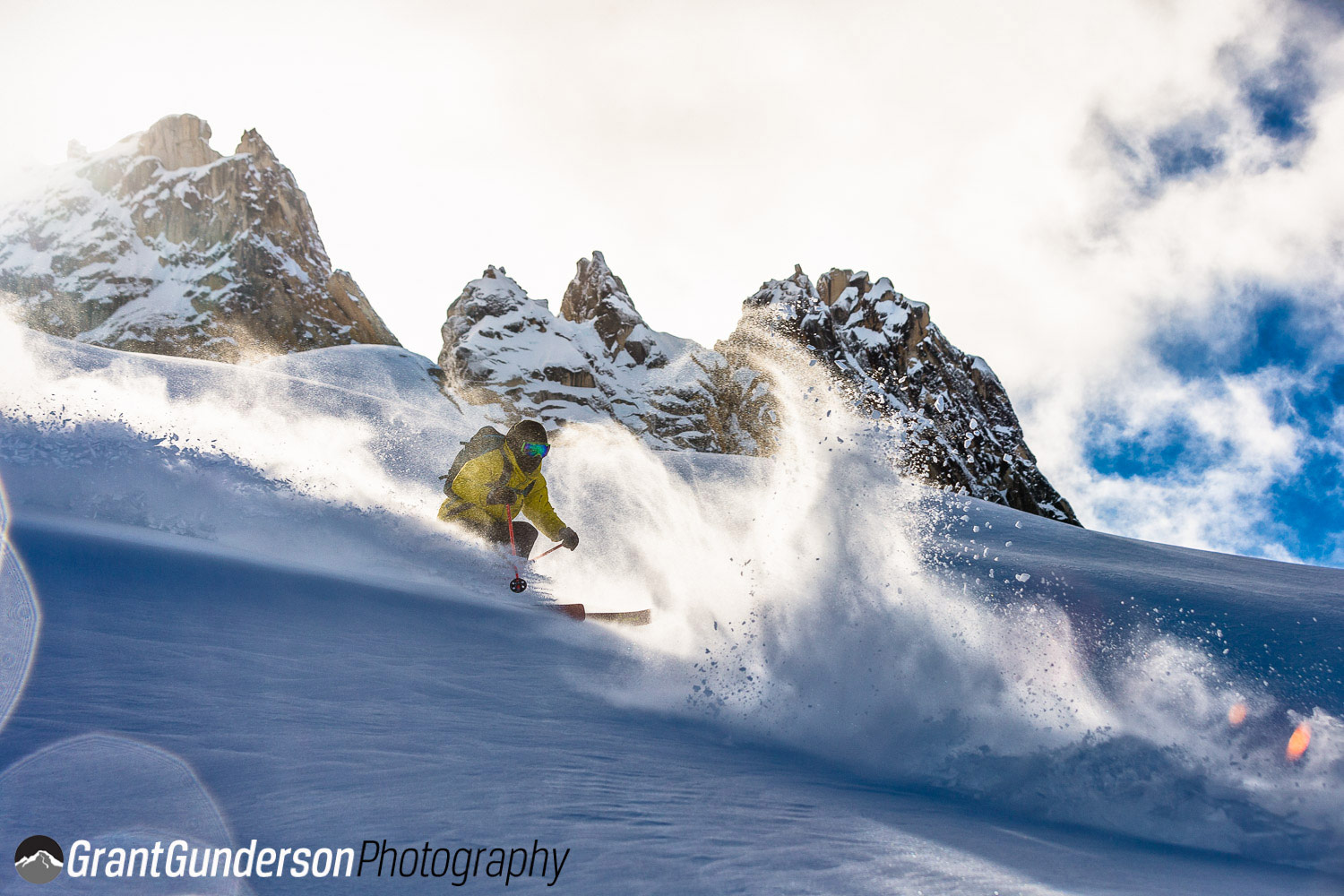 North Cascade Heliskiing – Mazama in USA - a man riding a snowboard down a snow covered slope.