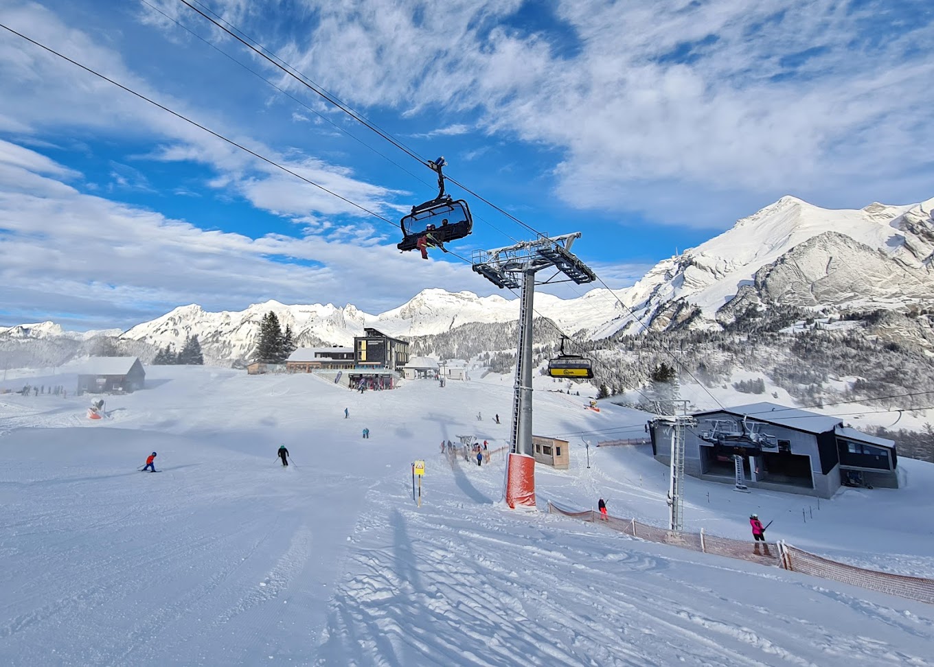 Bergbahnen Wildhaus in Switzerland - a ski lift going up a snowy slope.