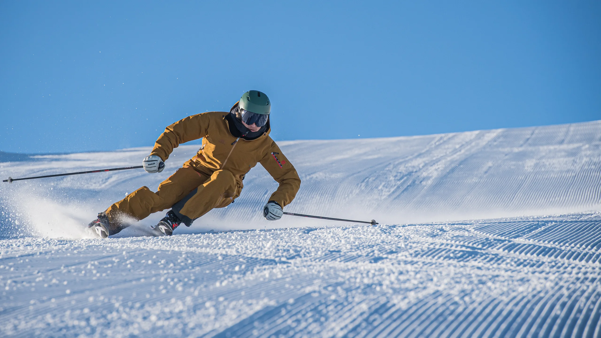 Bergbahnen Wildhaus in Switzerland - a man in a yellow jacket skiing down a slope.