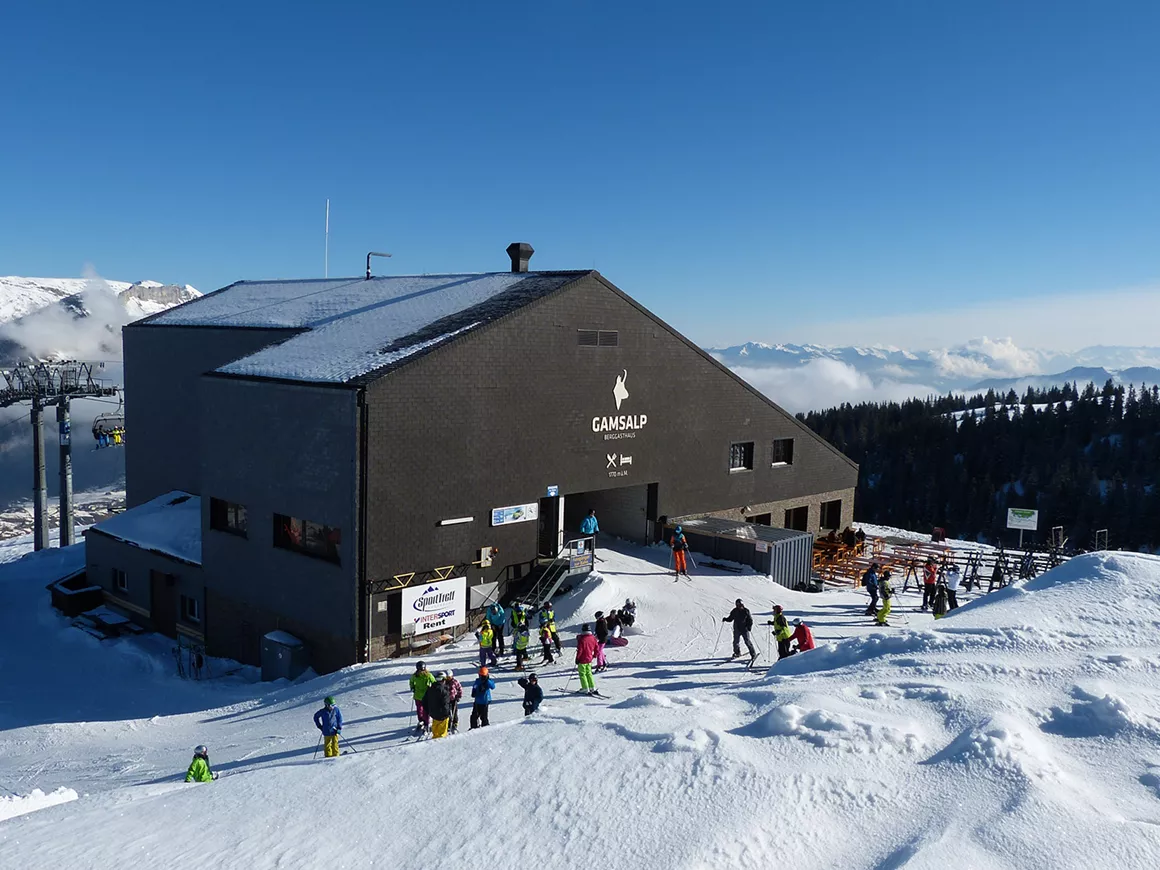 Bergbahnen Wildhaus in Switzerland - a group of people standing on top of a mountain.