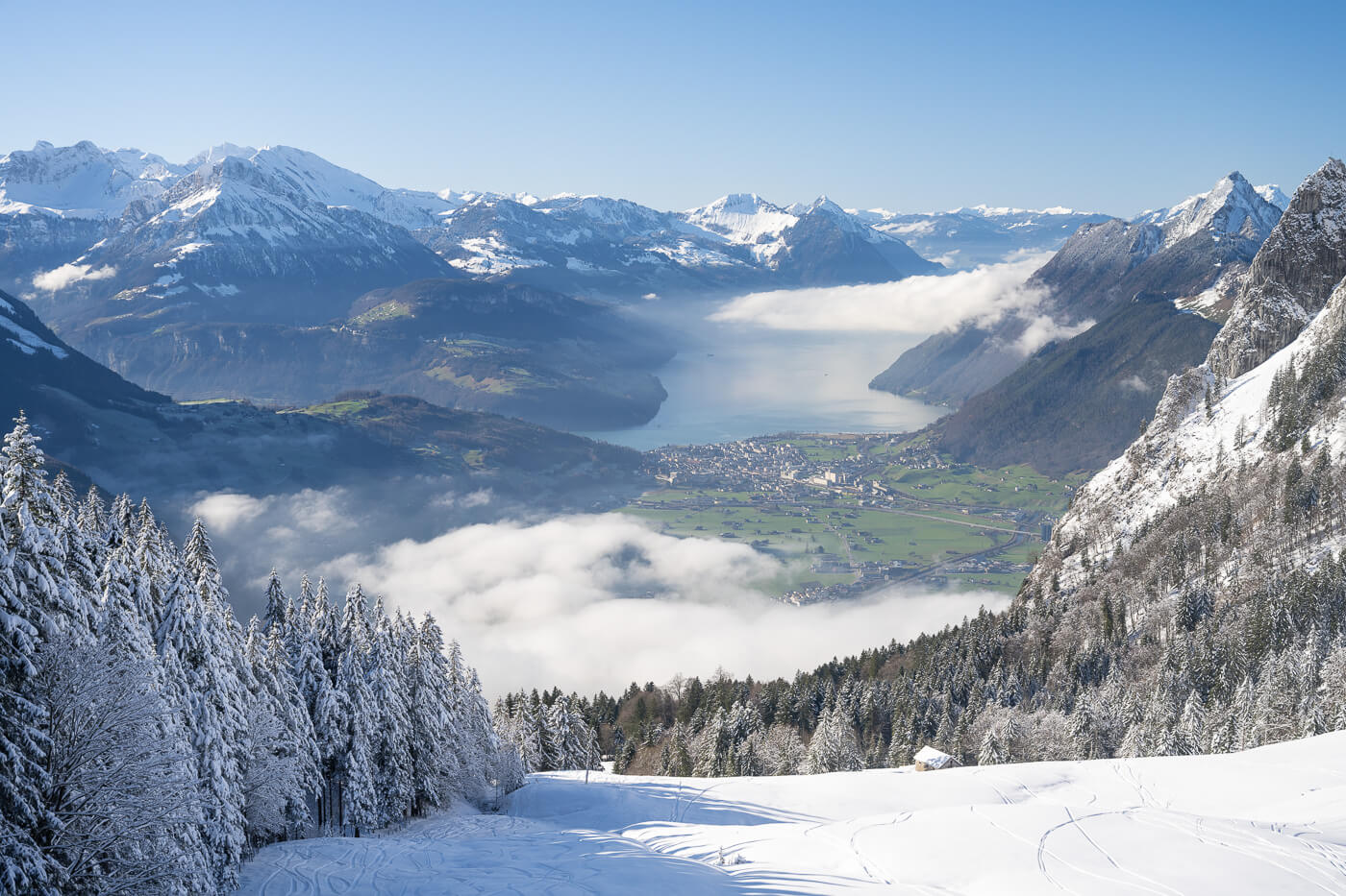 Mythenregion in Switzerland - a view of snow covered mountains and a lake.