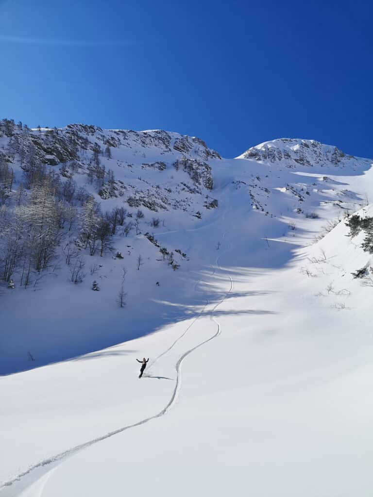 Kanin-Sella Nevea Ski Resort in Slovenia - a person skiing down a snow covered mountain.