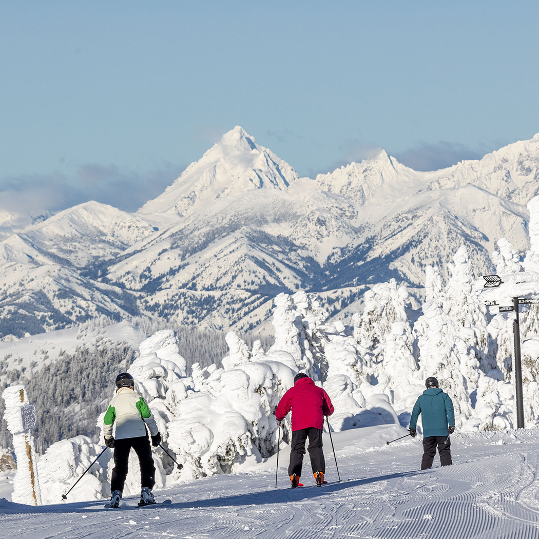 Mission Ridge WA in USA - a group of people skiing down a mountain.