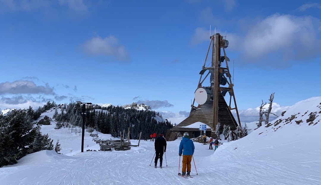 Mission Ridge WA in USA - a group of people skiing down a snow covered mountain.