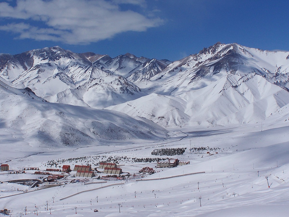 Las Leñas in Argentina - a snow covered mountain with a small town in the fore.
