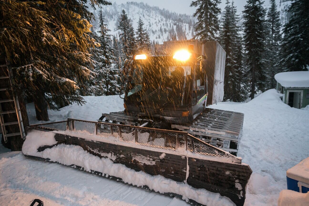 Cascade Powder Guides in USA - a snow pling machine is parked in the snow.