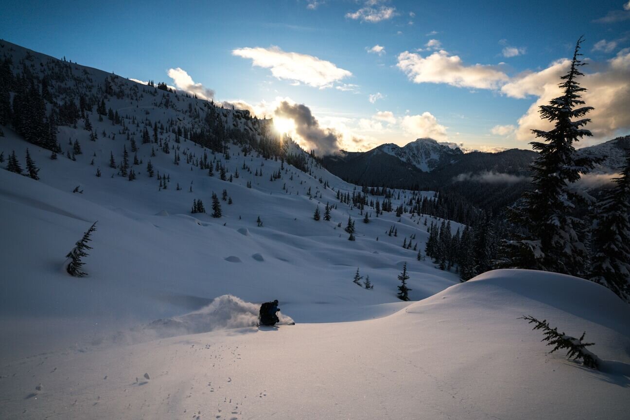 Cascade Powder Guides in USA - a person skiing down a snow covered mountain.