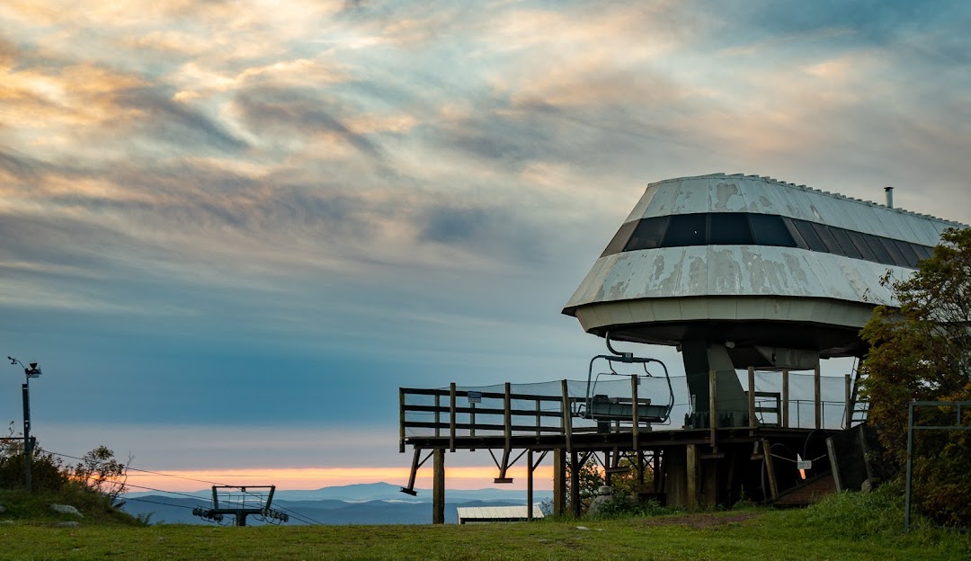 Bromley Mountain in USA: a large white building sitting on top of a green hill.