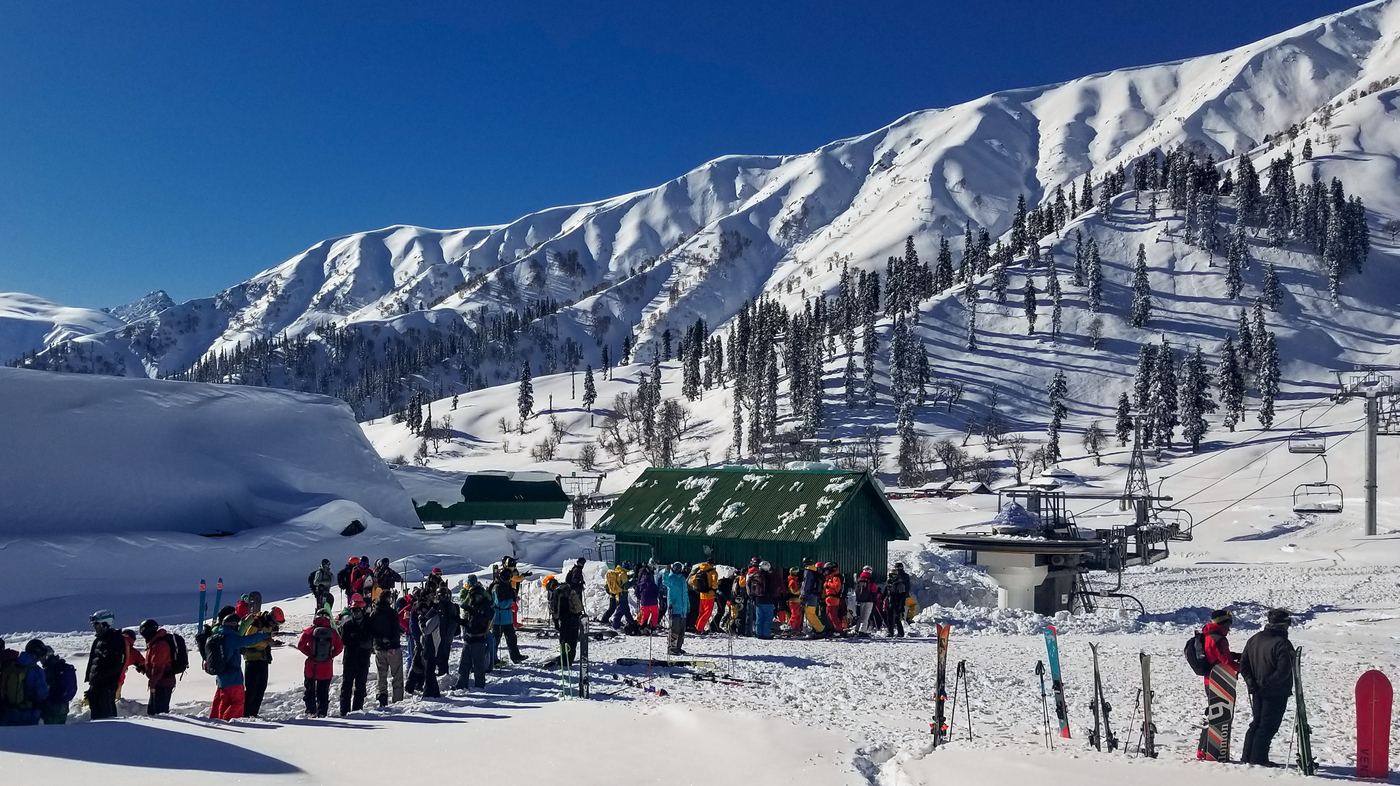Gulmarg Ski Resort in India - a group of people standing in the snow.