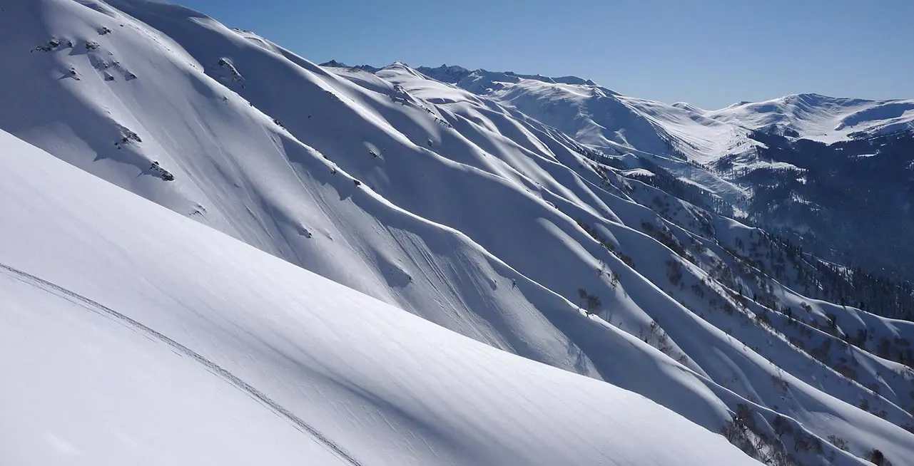 Gulmarg Ski Resort in India - a view from the top of a snowy mountain.